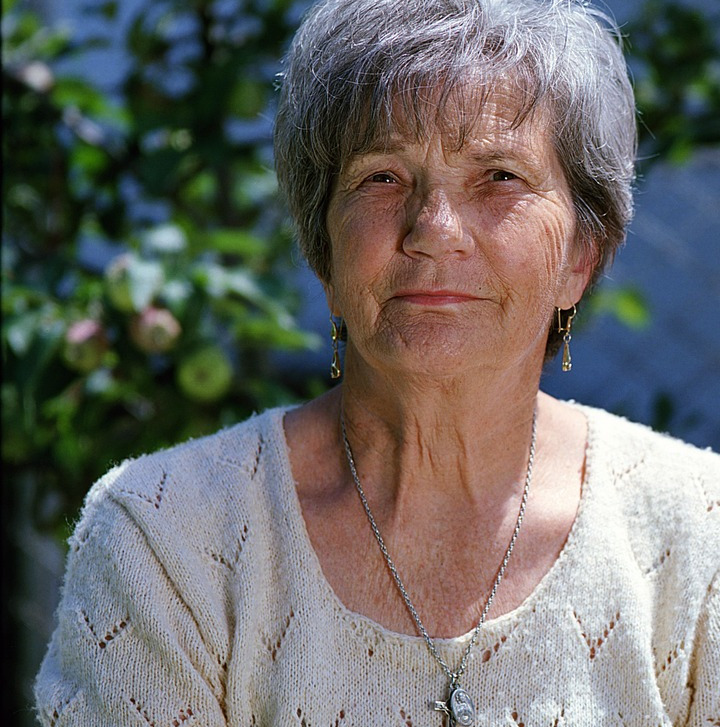 caregiver supporting senior smiling